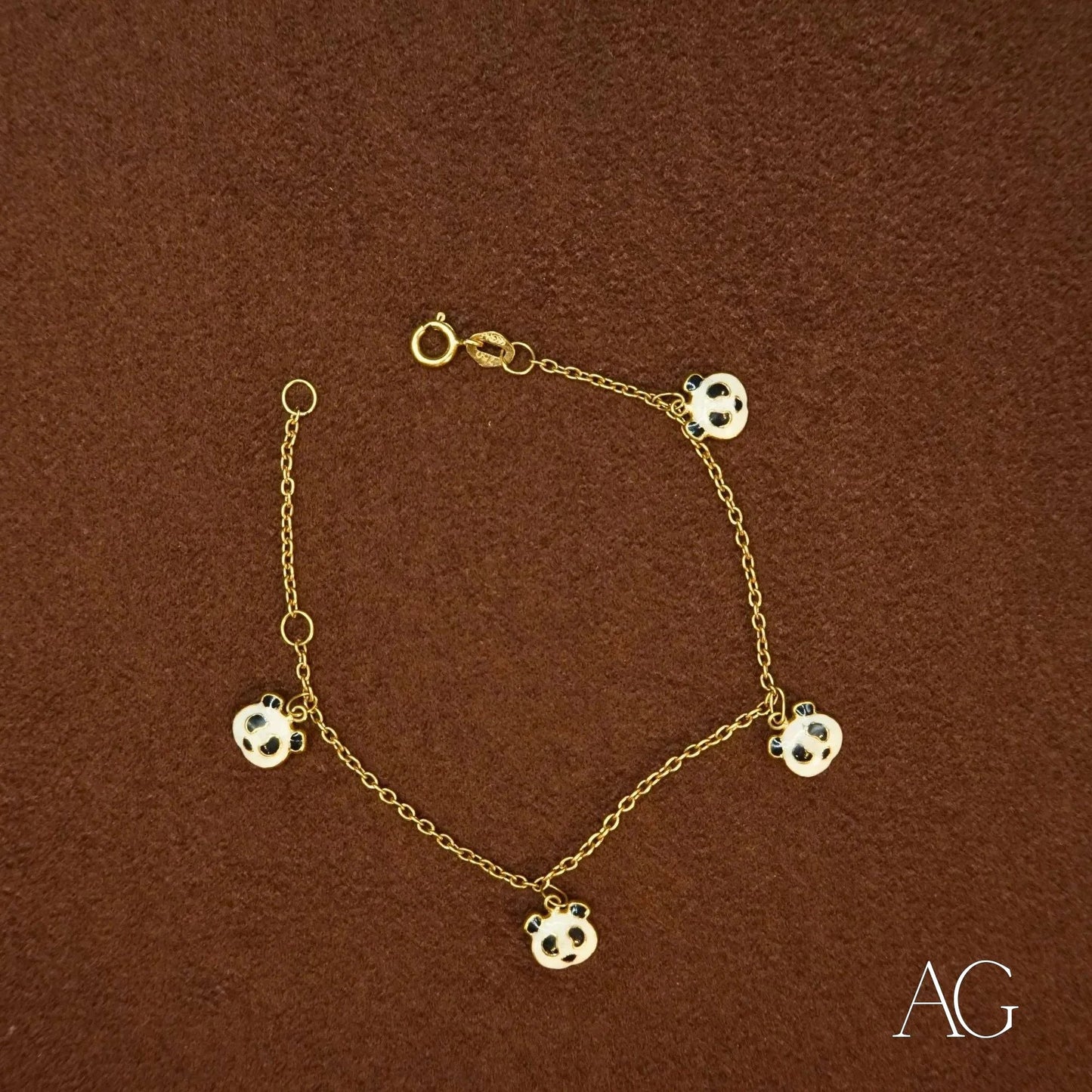 18k gold bracelet featuring soccer ball charms and a gold panda design