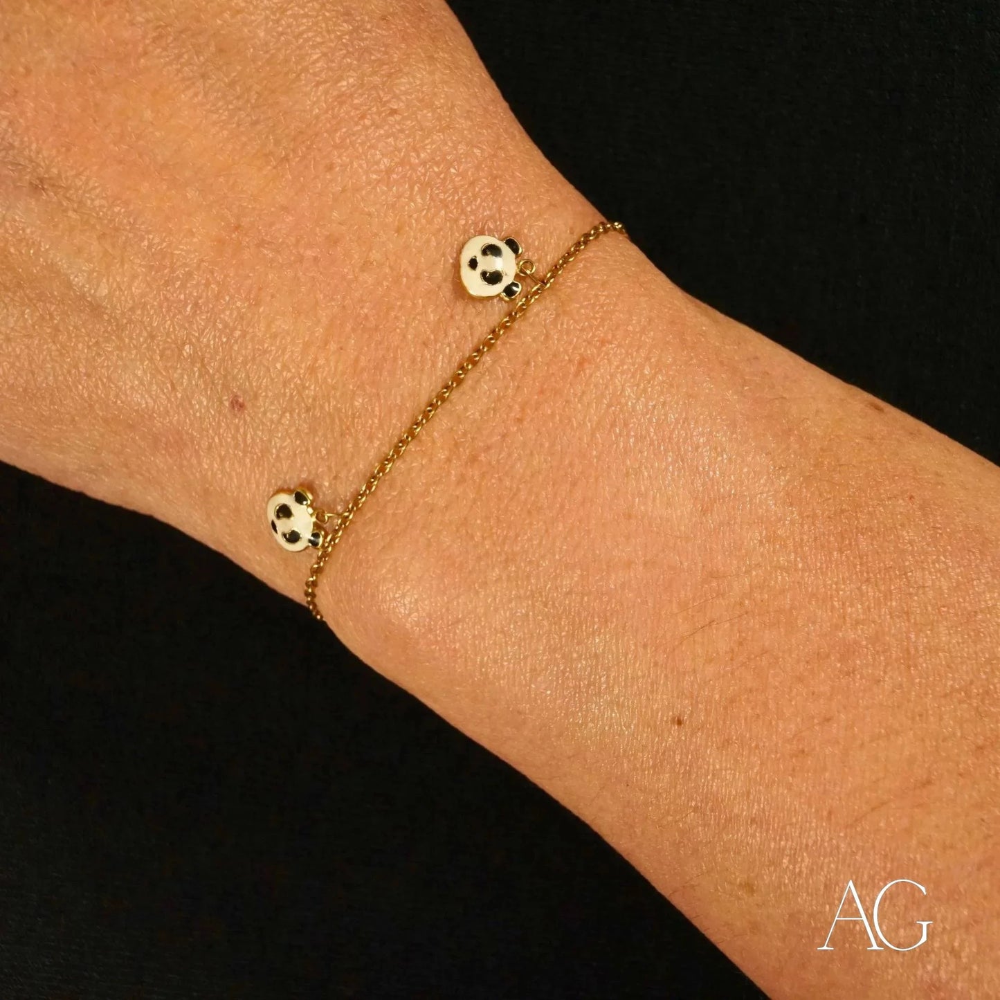 Delicate 18k gold panda bracelet featuring a chain and two spotted beads