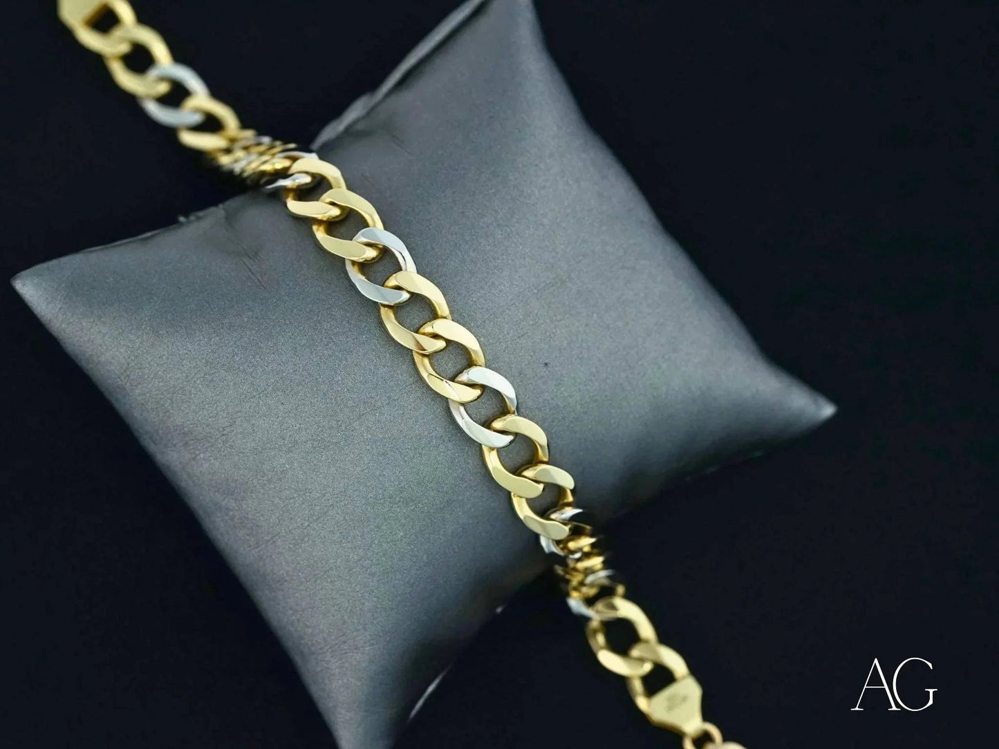 Gold chain bracelet on gray cushion showcasing elegant art gold jewelry style