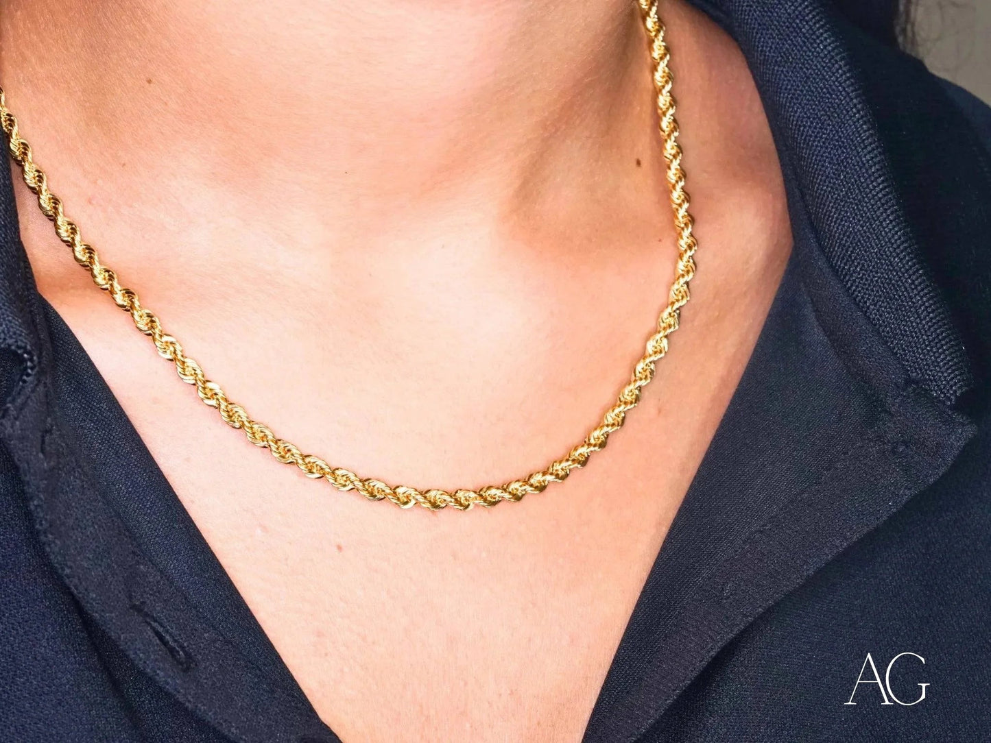 Elegant 18k gold rope chain necklace worn around the neck, showcasing timeless style