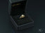 Gold engagement ring with center diamond displayed in a black jewelry box