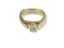 Gold engagement ring Embrace of Light featuring a center diamond and smaller diamonds
