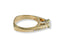 Gold engagement ring with a center diamond and smaller diamonds in 18k gold setting