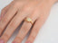 Gold engagement ring featuring a center diamond and halo in 18K yellow gold setting
