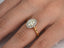 Diamond engagement ring in 18k gold with oval-cut center stone in eternal halo setting