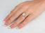 Eternal Halo Engagement Ring in 18k gold on hand with French manicure nails