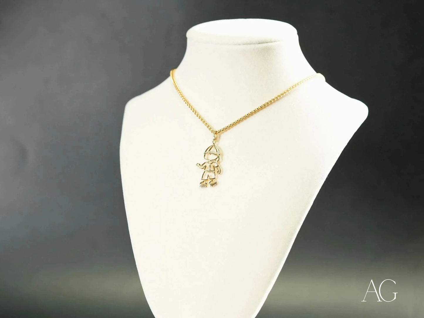 18k gold Golden Cherish Pendant featuring a boy-shaped design on a display bust