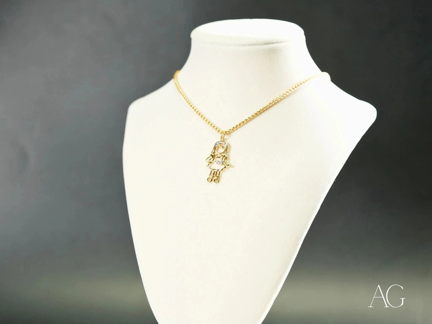 Gold Hamsa hand pendant necklace on white bust, part of Golden Cherish line