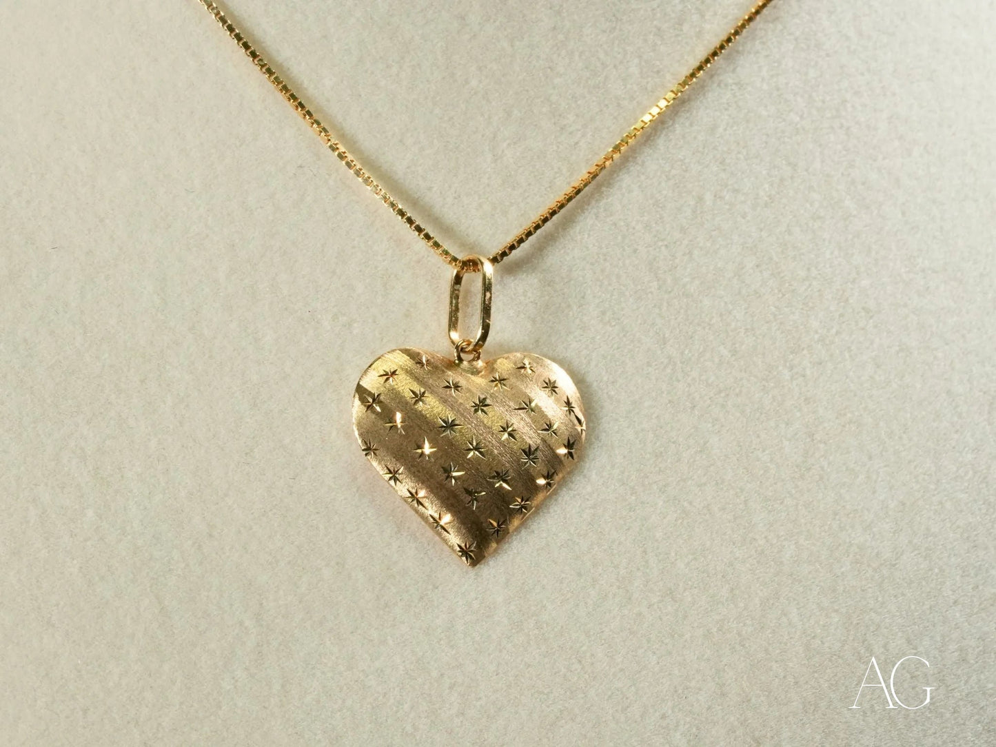 18k gold golden heart pendant with textured pattern on a stylish chain necklace