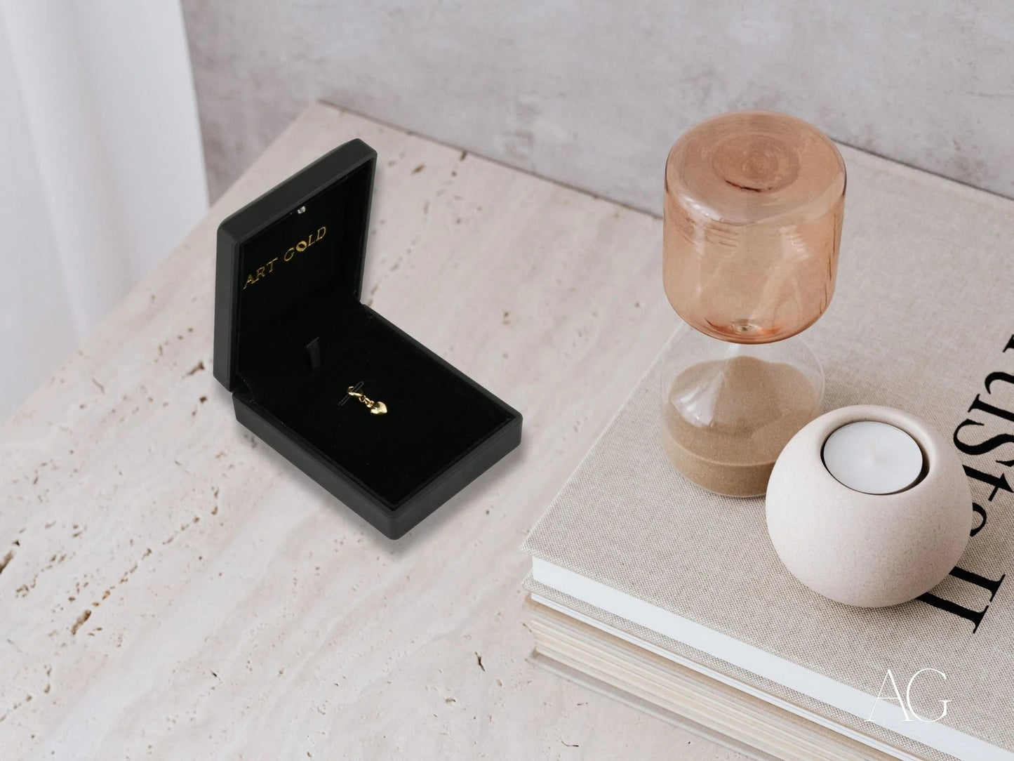 18k gold heart pendant displayed in a black velvet jewelry box with a ring