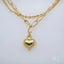 Luxurious 18k double chain anklet with a heart charm, showcasing elegant gold craftsmanship.
