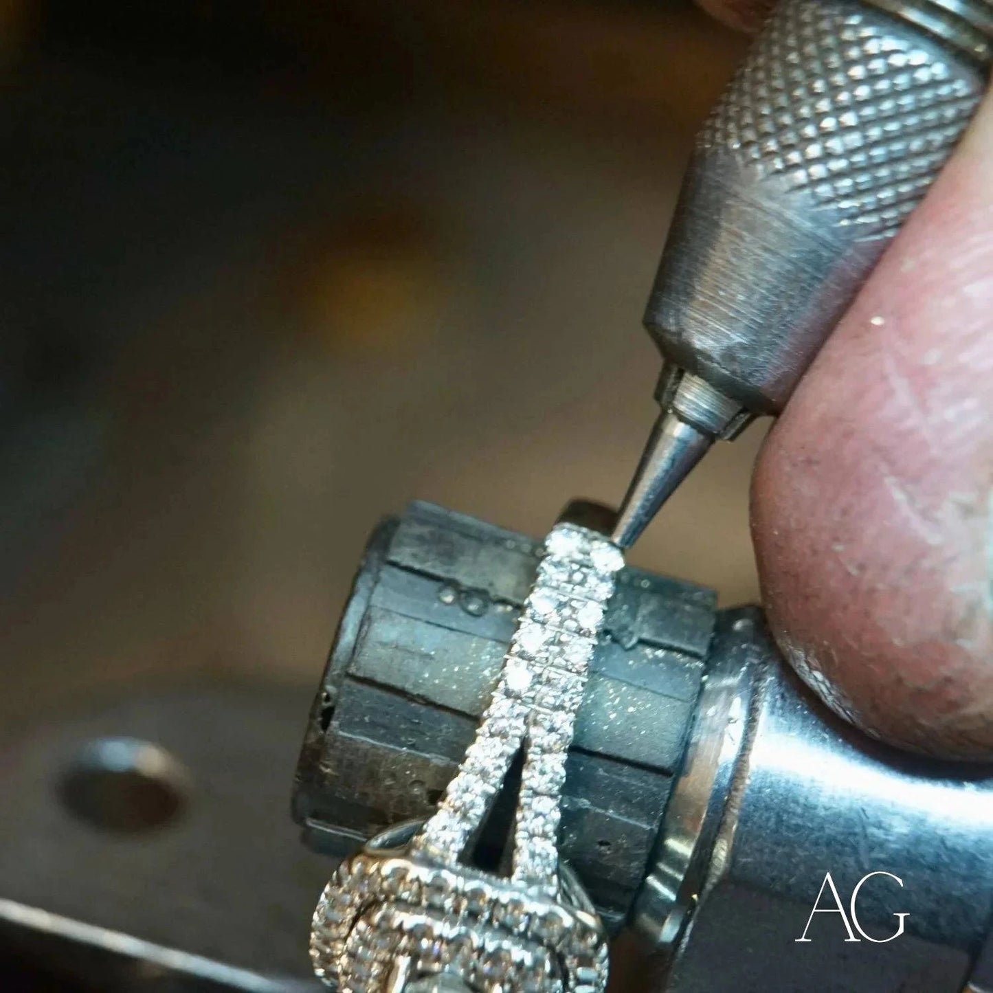 Jeweler repairing diamond-encrusted ring at Art Gold Jewelry repair workshop