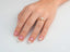Diamond engagement ring in 18k gold on woman’s hand, showcasing a stunning focal point