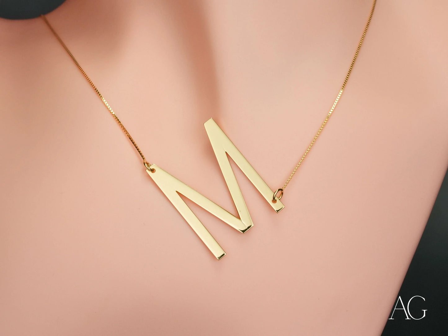 Gold initial letter pendant necklace featuring a letter pendant necklace with personalized design