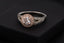 silver diamond ring on black box