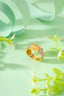 A gold ring sitting on top of a green surface