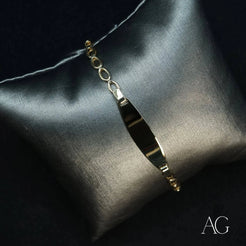 Sleek silver pendant necklace highlighting the elegance of an 18k gold ID bracelet