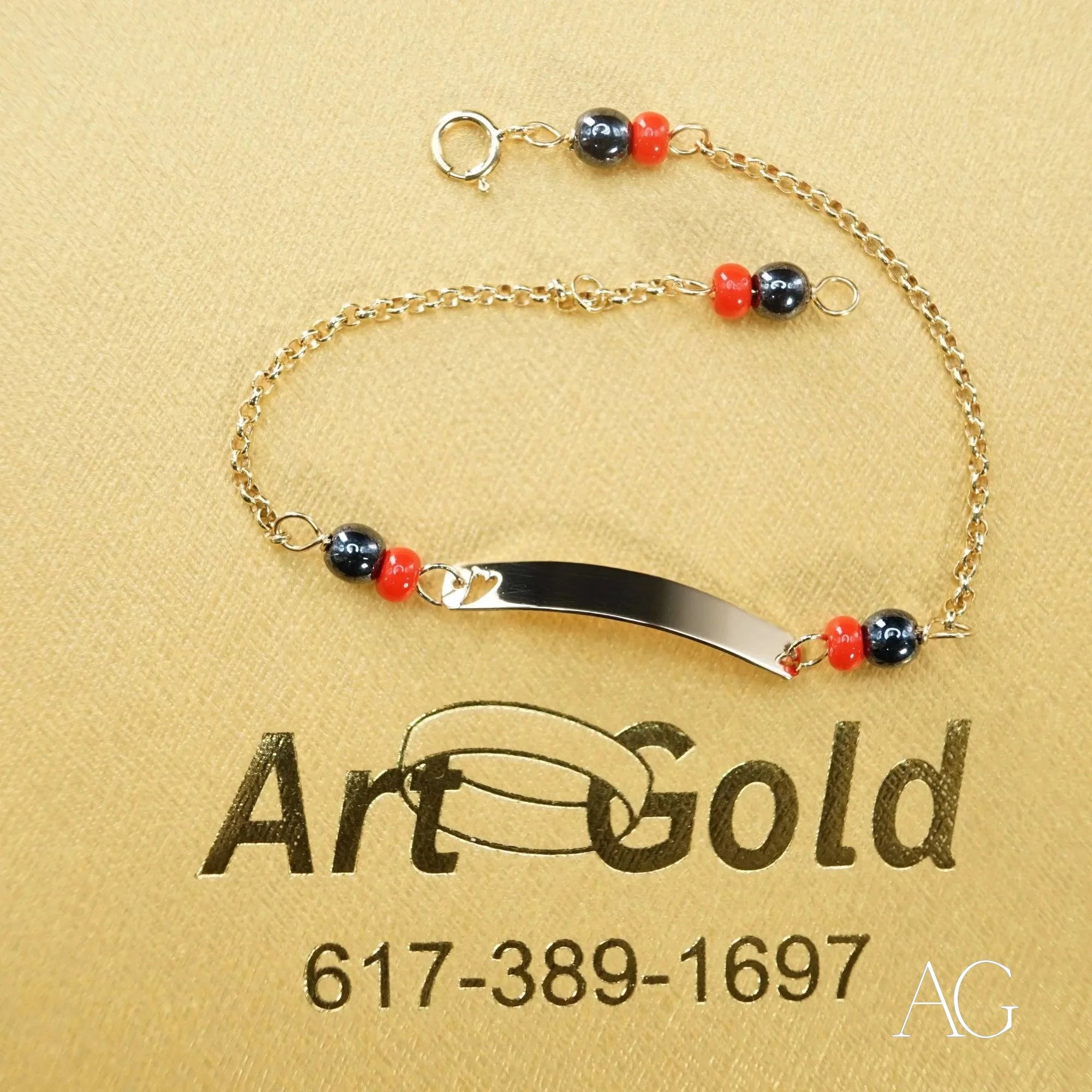 18k gold kids bracelet featuring black coral, colorful beads, and heart symbol design