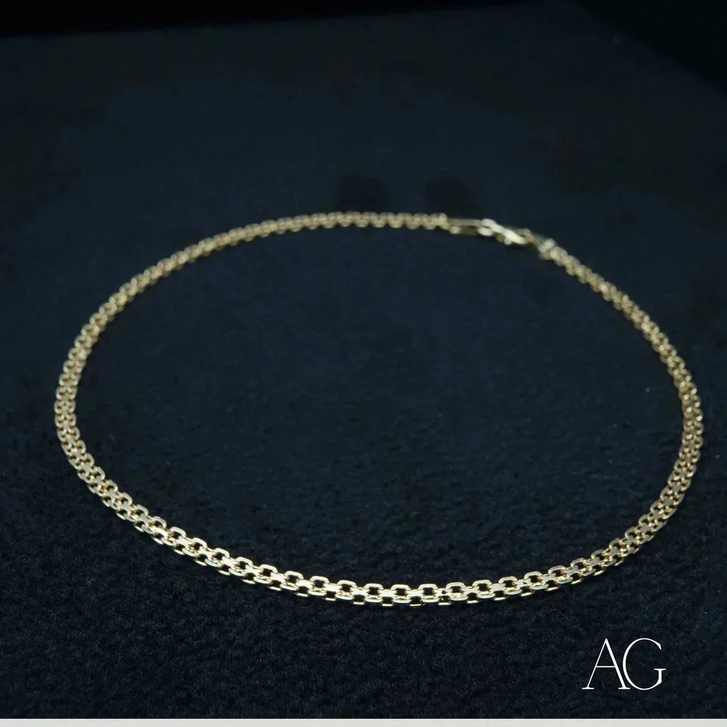 18k gold anklet on a dark background, showcasing modern elegance and minimalist design.