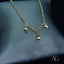 18k Gold Heart Charm Anklet with three heart charms on display.