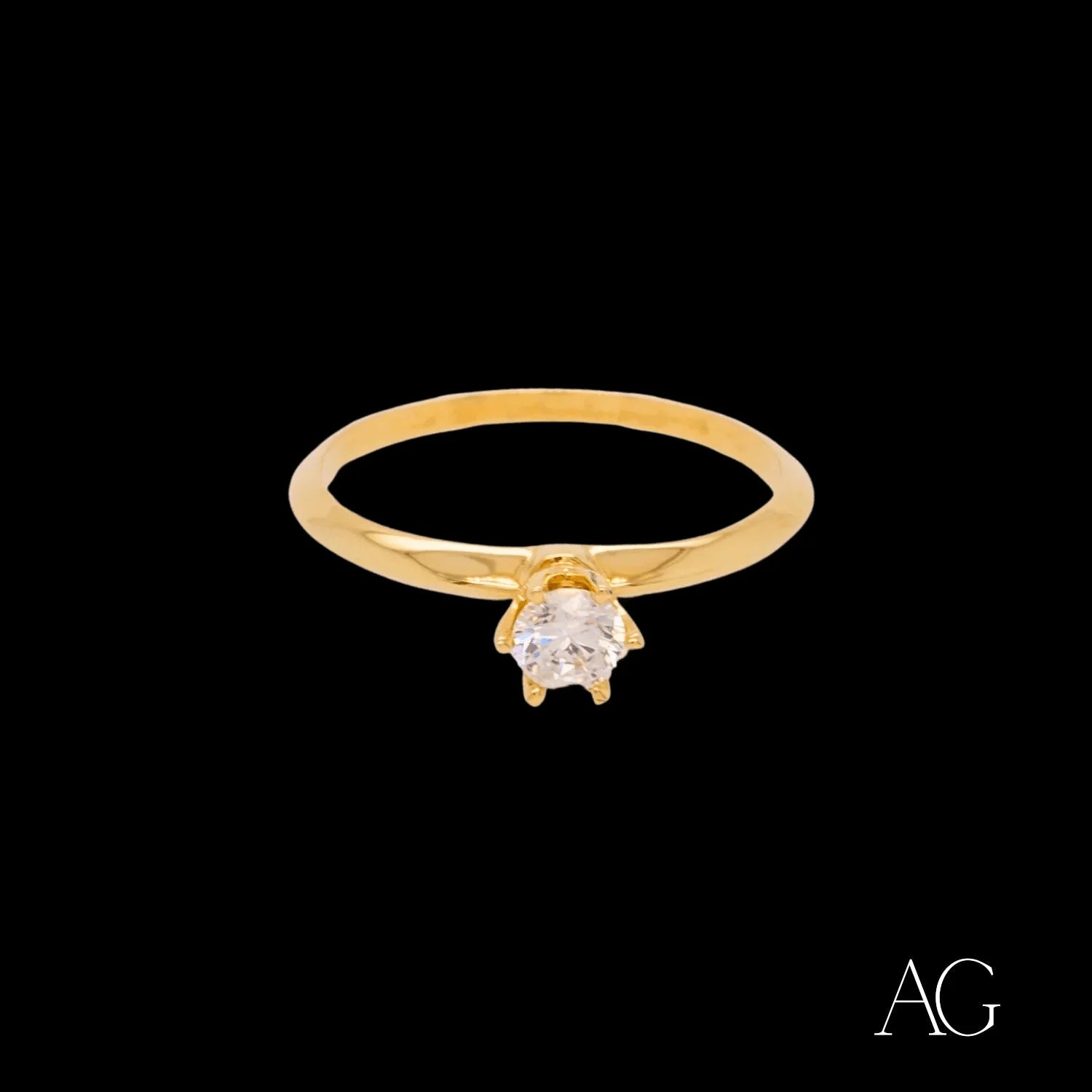 Gold solitaire ring with a round diamond in 18k cz, showcasing timeless elegance