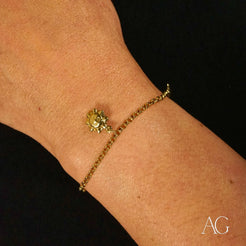 Delicate 18k gold charm bracelet for kids with a small sun charm design