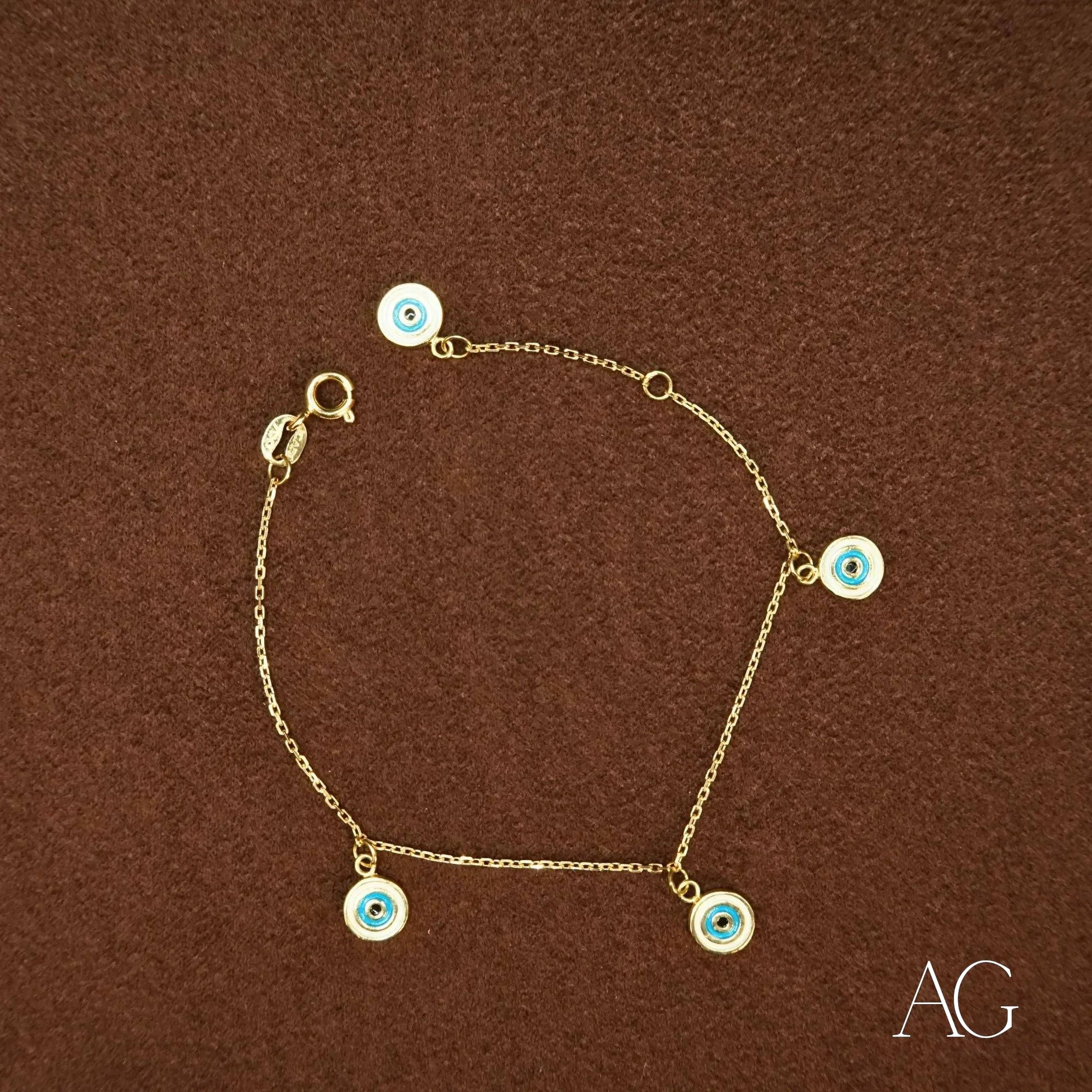 Gold chain bracelet with light blue evil eye charms in 18k gold for kids