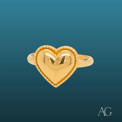 Gold heart-shaped 18k gold heart ring with embossed M symbolizing timeless love