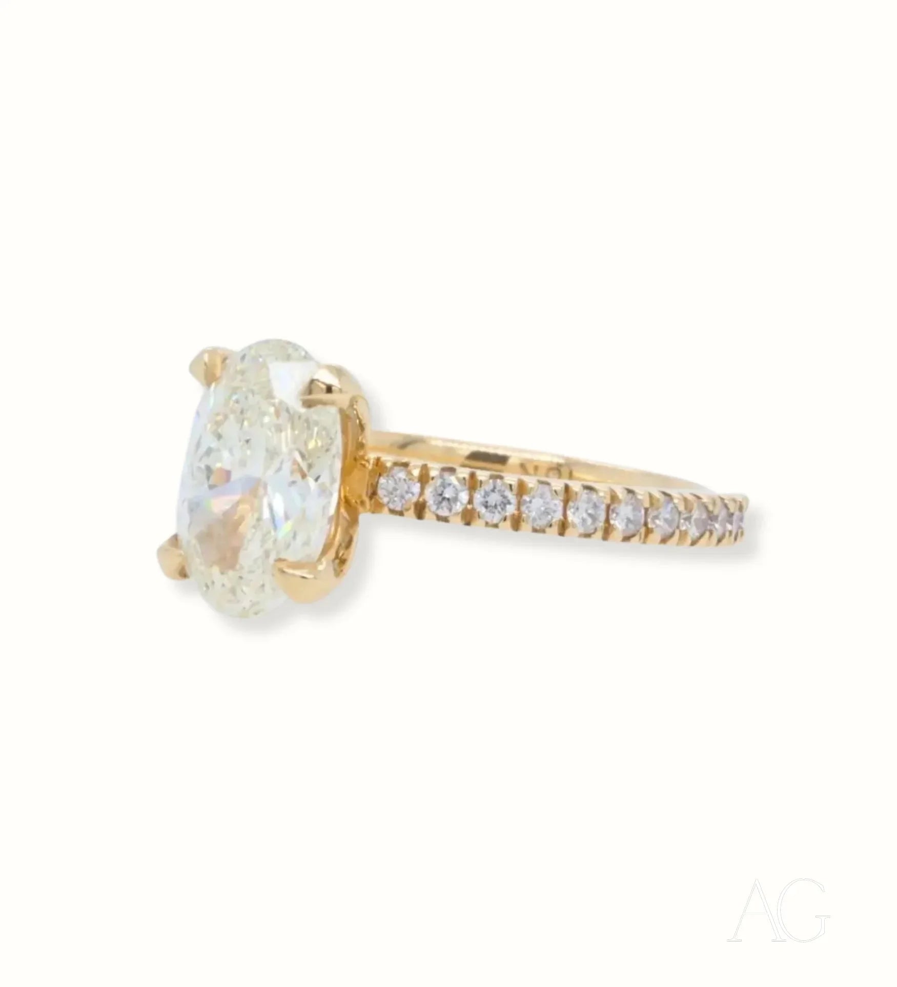 Elegant 18k Gold Engagement Ring with Oval Diamond and accent diamonds on the band