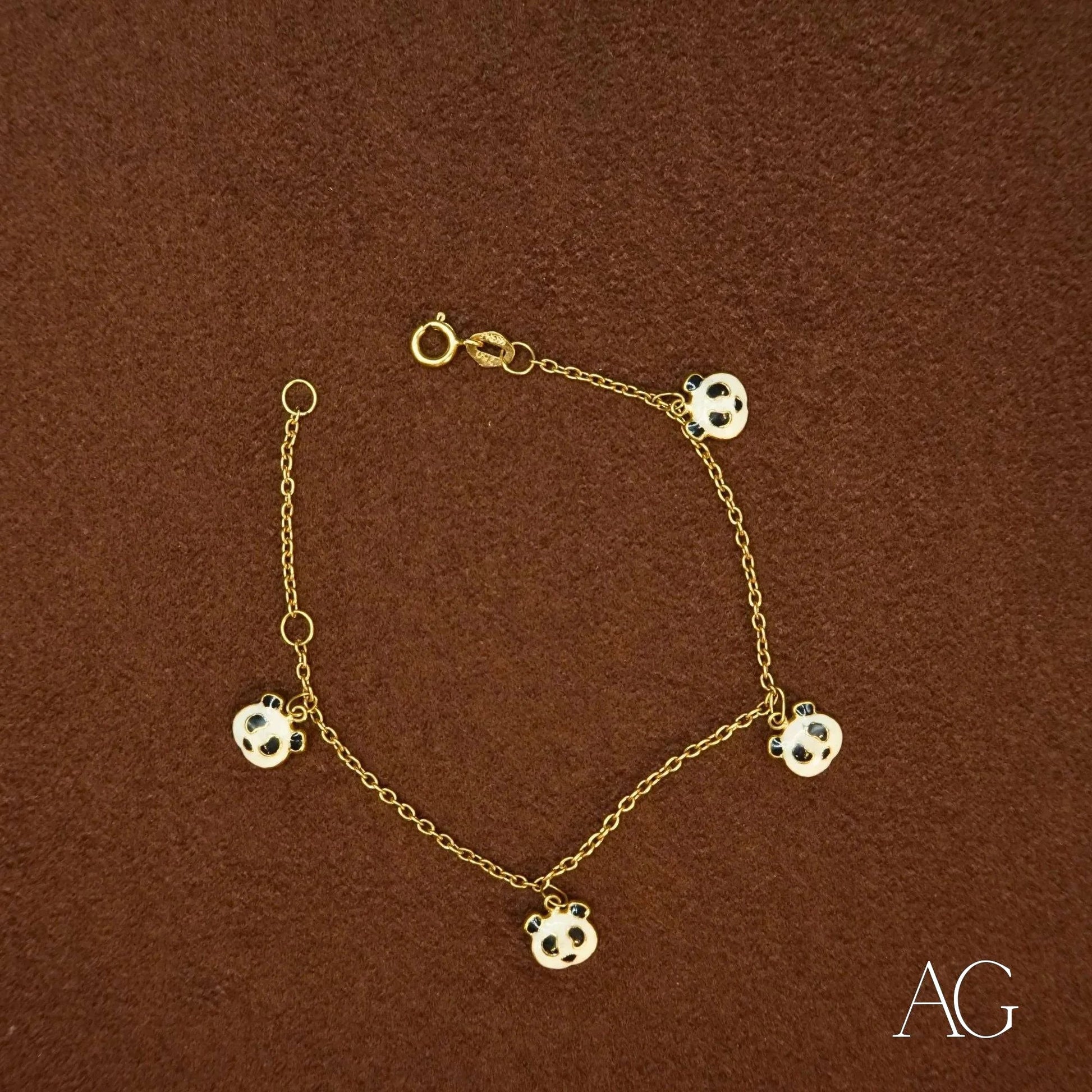 18k gold bracelet featuring soccer ball charms and a gold panda design