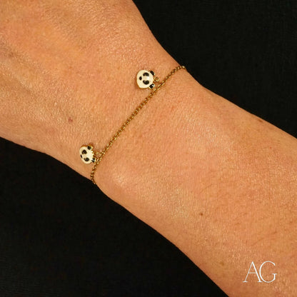 Delicate 18k gold panda bracelet featuring a chain and two spotted beads
