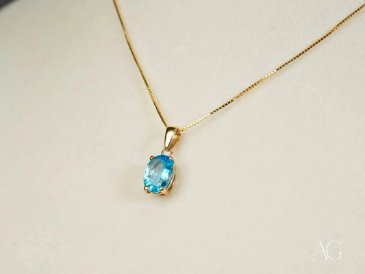Gold necklace featuring an oval Blue Topaz pendant from the Azure Gleam collection