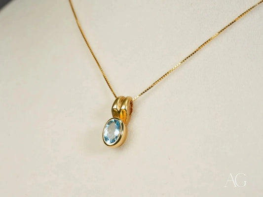 Gold necklace featuring a stunning blue topaz gemstone pendant in 18k gold