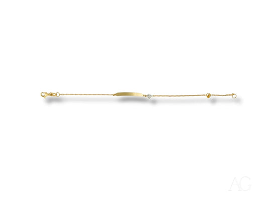 Thin gold-colored pin with decorative heart motif on a personalized ID bracelet with lobster lock