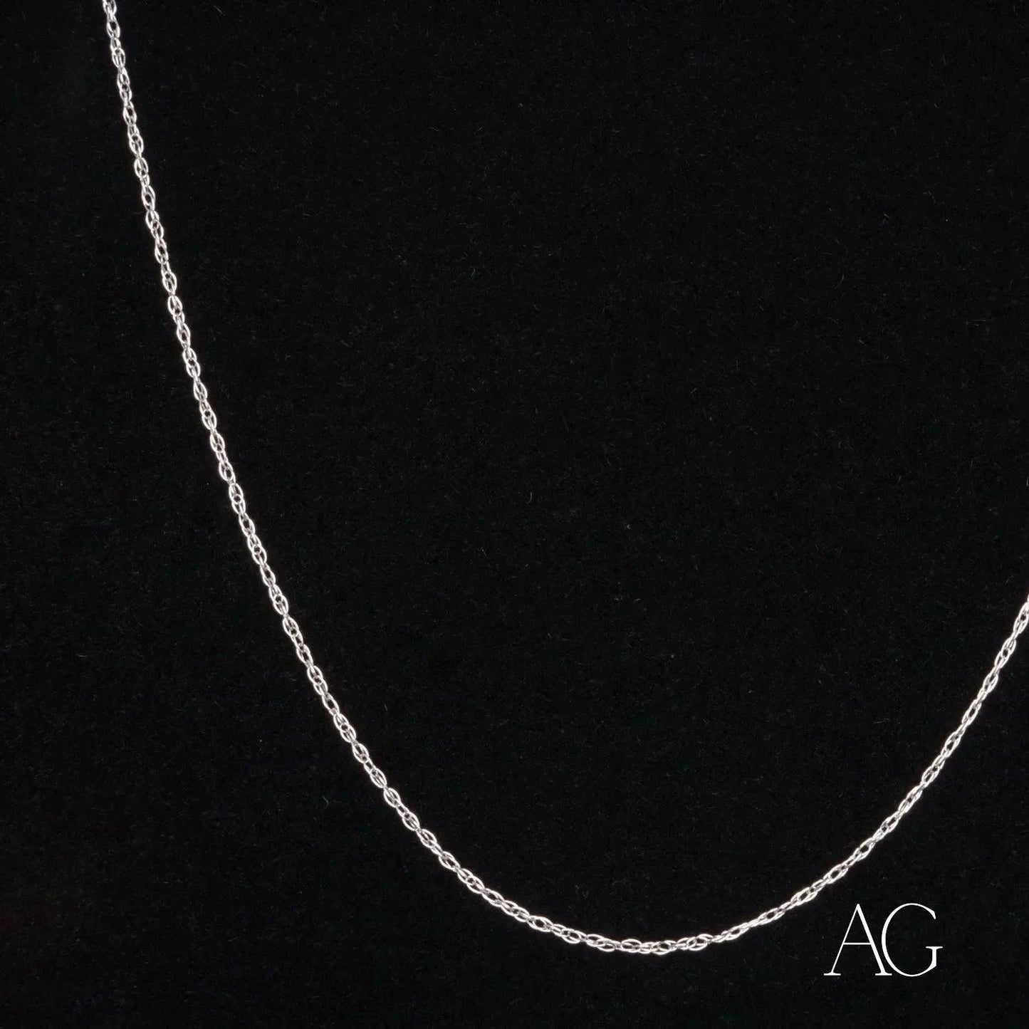 Dainty 14k white gold rope chain necklace on a dark background