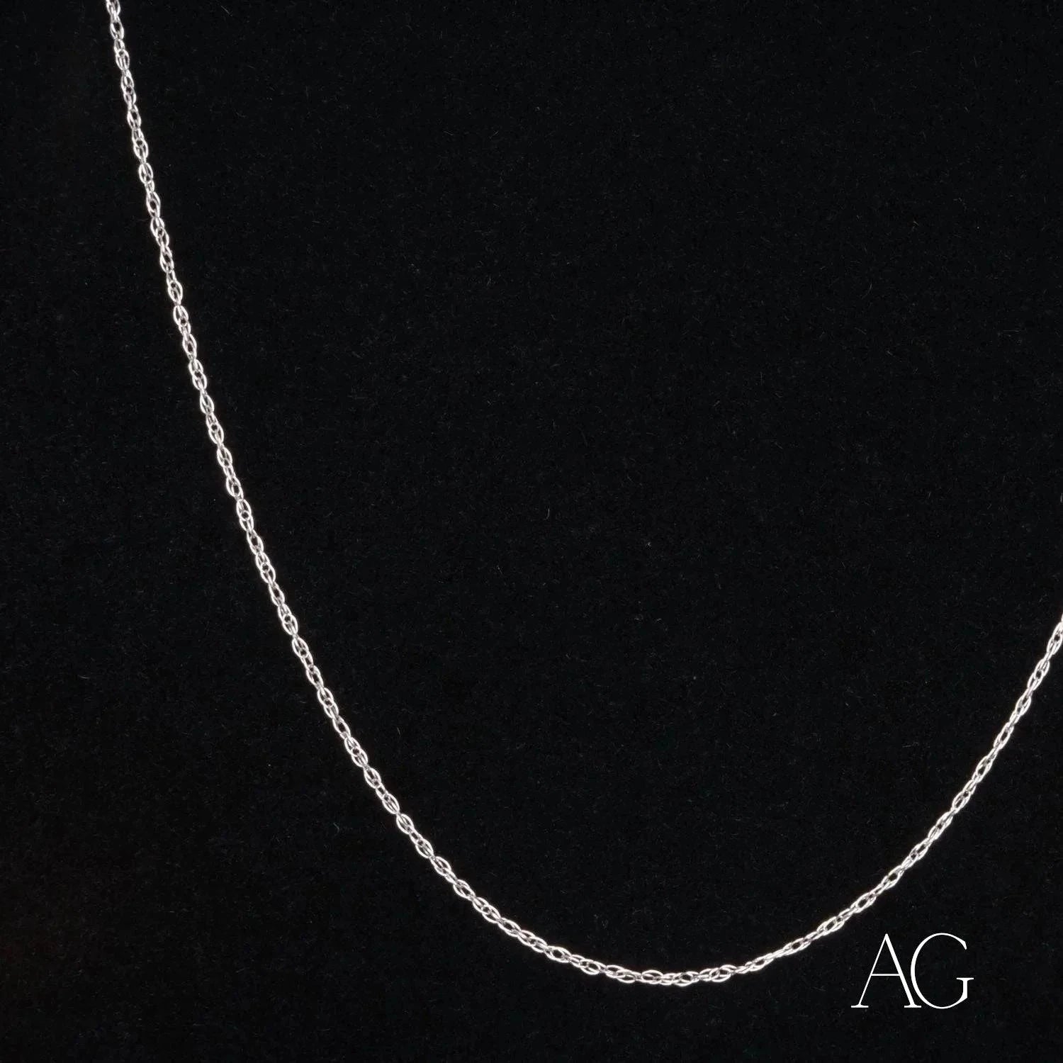 Dainty 14k white gold rope chain necklace on a dark background
