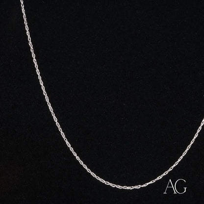 Dainty 14k white gold rope chain necklace on a dark background