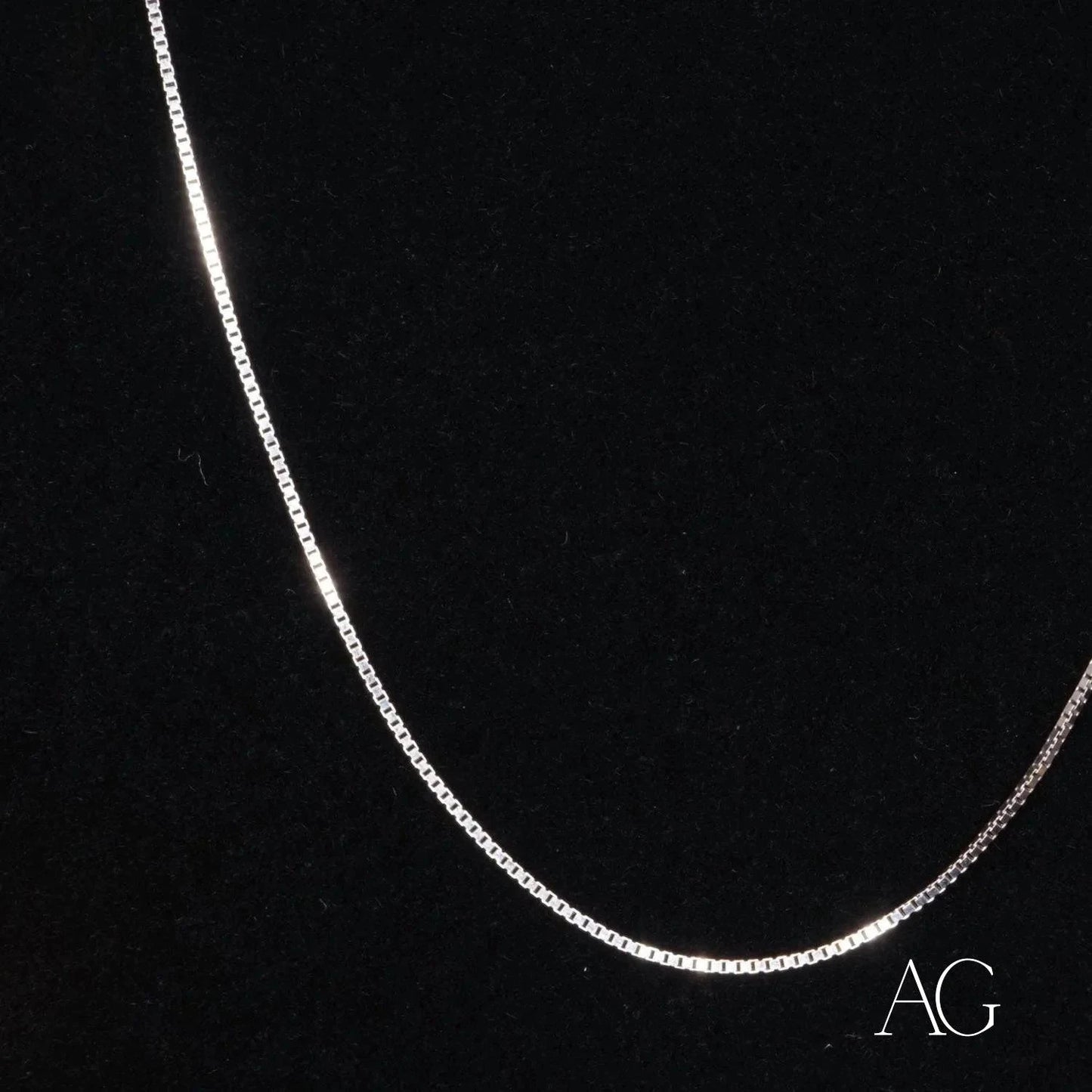 Delicate 14k gold box chain necklace featuring a stylish curved design