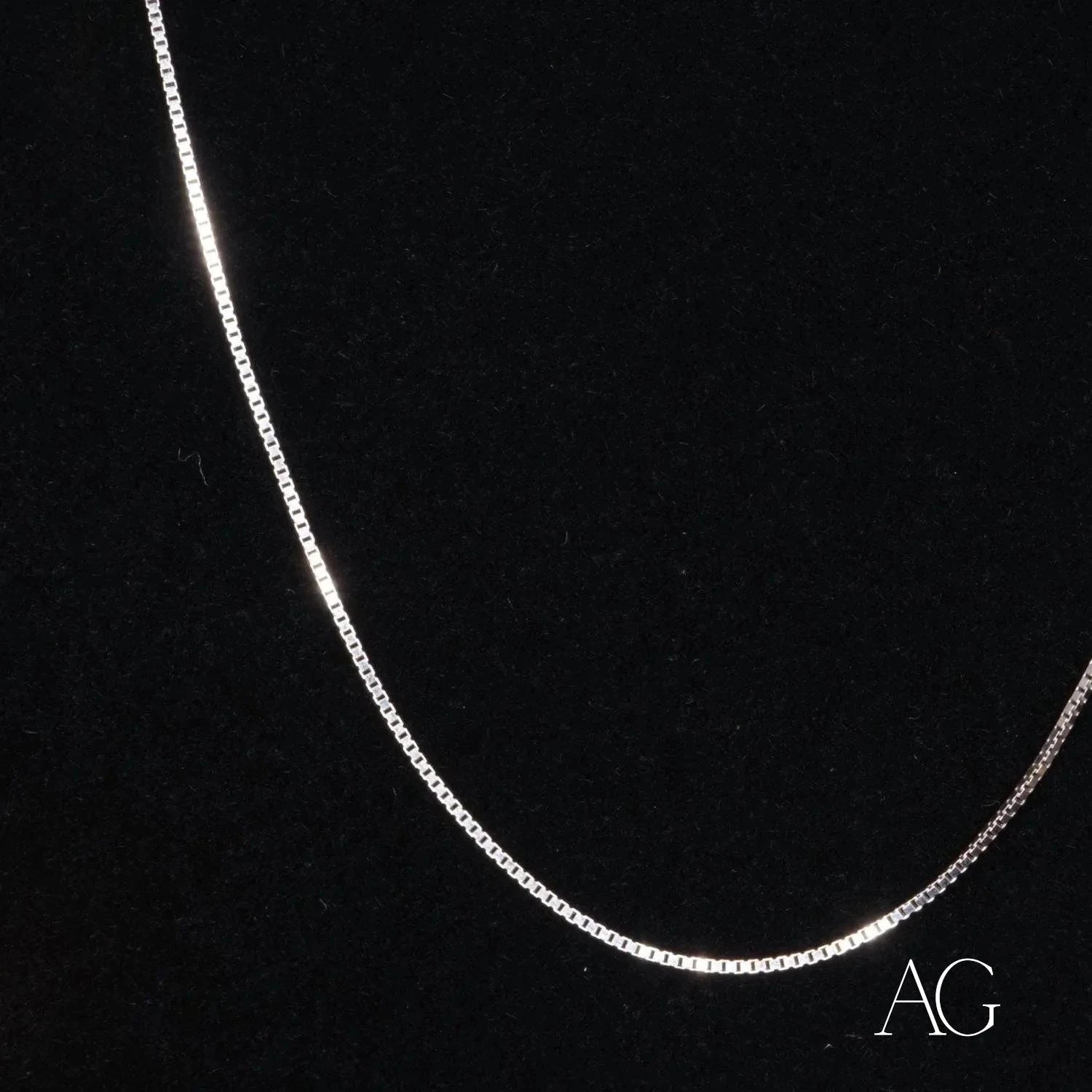Delicate 14k gold box chain necklace featuring a stylish curved design