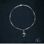 18k gold anklet with dolphin charm by Art Gold Jewelry, showcasing marine elegance.