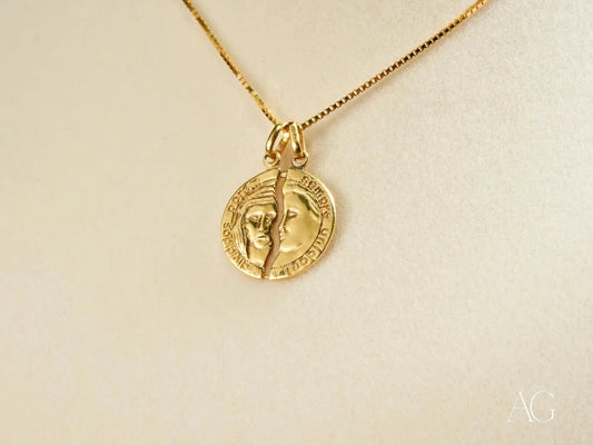 Gold pendant necklace with embossed profiles in 18k gold showcasing Dual Harmony design
