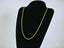 Elegant 14k gold rope chain necklace with secure barrel lock on a black jewelry bust