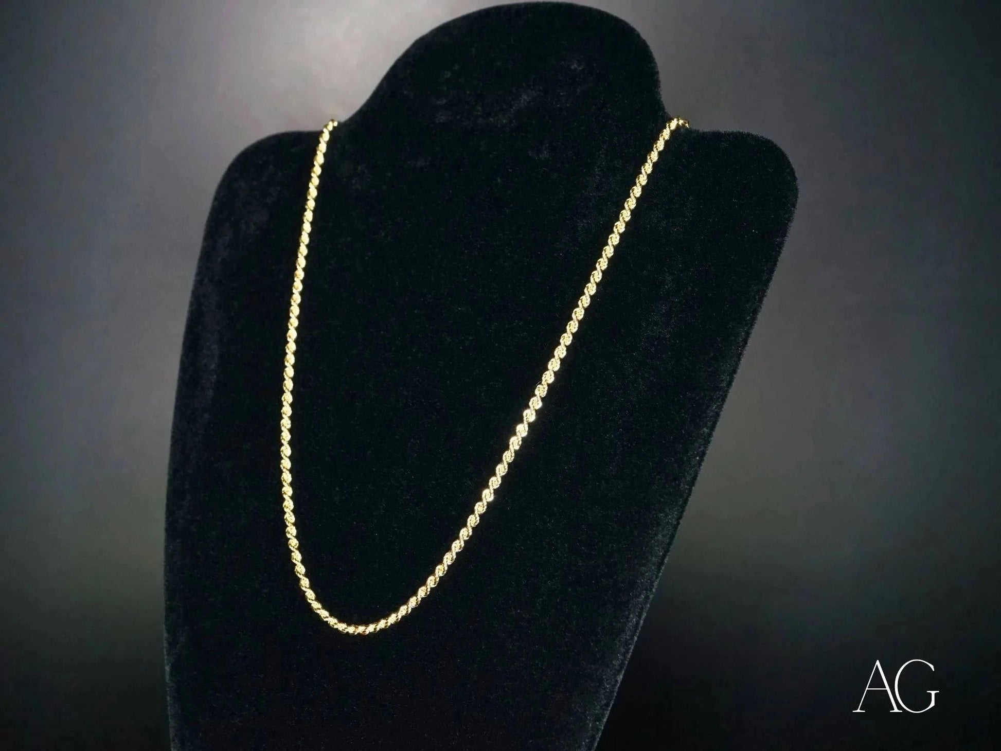 Elegant 14k gold rope chain necklace with secure barrel lock on black velvet stand