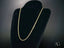 Elegant 14k gold rope chain necklace with secure barrel lock on black velvet stand