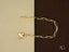 Elegant 18k gold chain necklace with heart-shaped lobster clasp and circular pendant