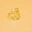 Gold-colored initial letter ring with ornate openwork design and curved elements