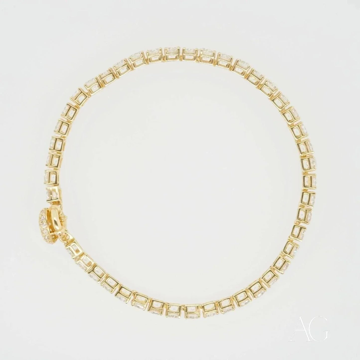 Gold tennis bracelet with square-cut gemstones, a stunning piece of art gold jewelry
