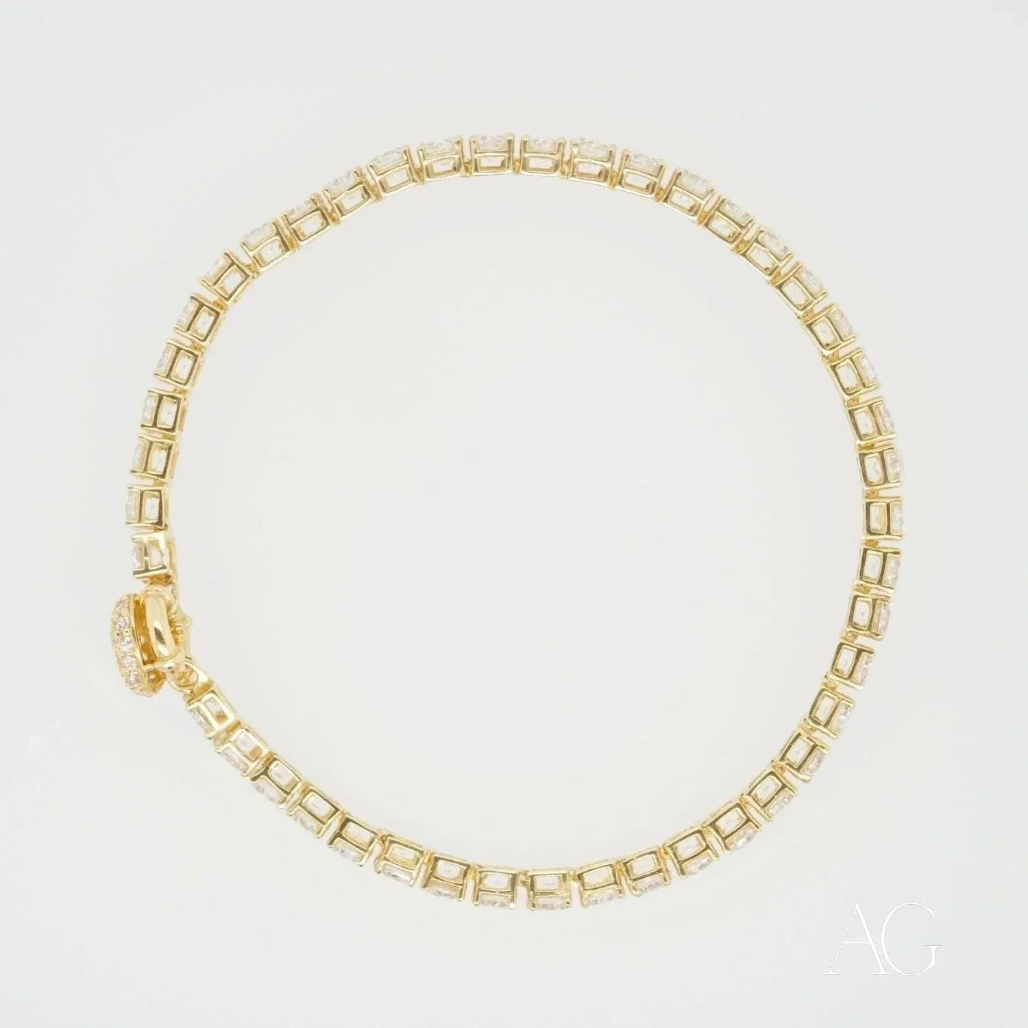Gold tennis bracelet with square-cut gemstones, a stunning piece of art gold jewelry
