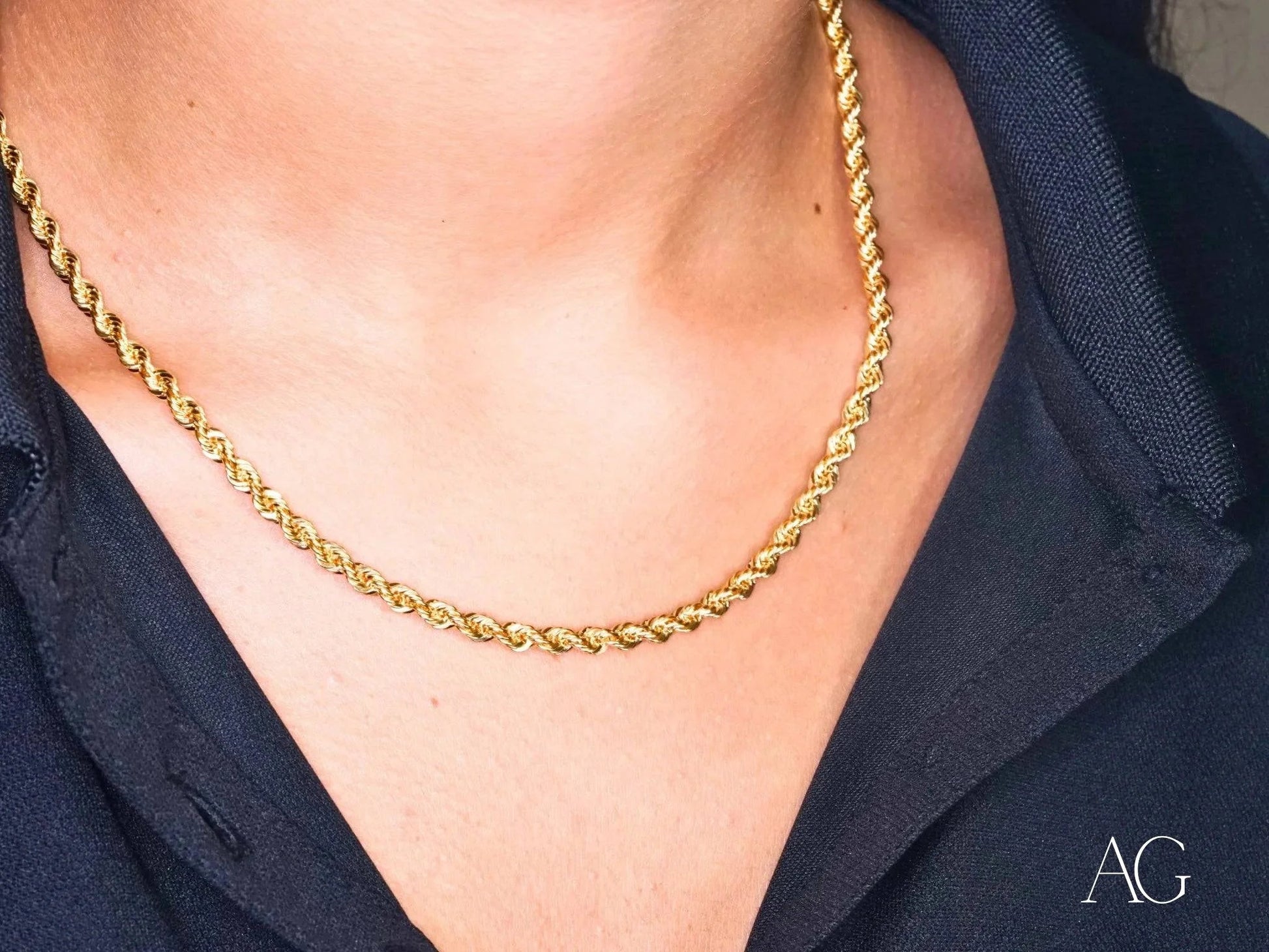 Elegant 18k gold rope chain necklace worn around the neck, showcasing timeless style