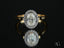 Diamond engagement ring in 18k gold with an oval center stone and eternal halo design